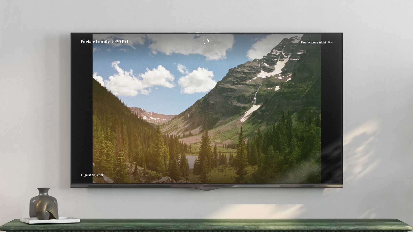 A TV showing a full-screen photo with the clock and next event in the corners